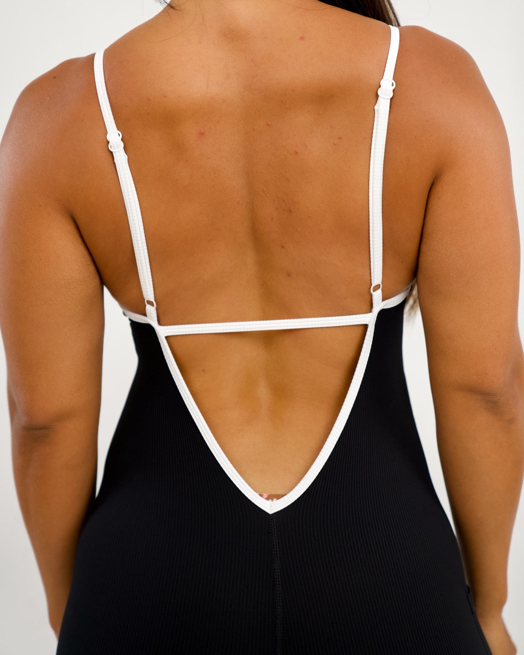 Azure V-Back Jumpsuit in Ribbed Black w/ Trim